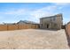 Expansive backyard with block wall fencing and patio, offering ample space for outdoor activities and landscaping at 21572 W Sonora St, Buckeye, AZ 85326