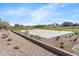 Outdoor basketball court surrounded by lush landscaping and beautiful homes at 21572 W Sonora St, Buckeye, AZ 85326