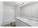 Well-lit bathroom featuring double sinks and a shower-tub combination at 21572 W Sonora St, Buckeye, AZ 85326
