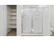 Bright bathroom featuring a walk-in shower and closet with shelving at 21572 W Sonora St, Buckeye, AZ 85326