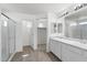 Beautiful primary bathroom featuring double sinks, walk-in shower, and walk-in closet at 21572 W Sonora St, Buckeye, AZ 85326