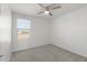 Bedroom with neutral carpeting, ceiling fan, and window for natural light at 21572 W Sonora St, Buckeye, AZ 85326