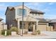 Home featuring a tile roof, two-car garage, solar panels, and low-maintenance desert landscaping at 21572 W Sonora St, Buckeye, AZ 85326