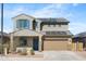 Two-story home featuring a tile roof, two-car garage, solar panels, and desert landscaping for low maintenance at 21572 W Sonora St, Buckeye, AZ 85326