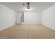 A spacious garage with painted floor, storage and lighting, providing ample space for vehicles and storage at 21572 W Sonora St, Buckeye, AZ 85326