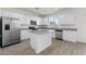 Bright modern kitchen featuring stainless steel appliances, a center island, and granite countertops at 21572 W Sonora St, Buckeye, AZ 85326