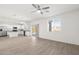 Open-concept kitchen and living area featuring wood-look flooring and stainless steel appliances at 21572 W Sonora St, Buckeye, AZ 85326
