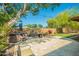 Outdoor living space featuring a hot tub, patio, seating area, and mature trees providing shade at 2246 E Glenrosa Ave, Phoenix, AZ 85016