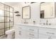 Modern bathroom with double vanity, stylish mirrors, and sleek shower enclosure, offering a spa-like experience at 2246 E Glenrosa Ave, Phoenix, AZ 85016