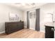 Cozy bedroom features a Murphy bed, ceiling fan, gray curtains, and natural light from the window at 2246 E Glenrosa Ave, Phoenix, AZ 85016