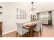 Elegant dining space with modern chandelier, wooden table, comfortable seating, and natural light at 2246 E Glenrosa Ave, Phoenix, AZ 85016