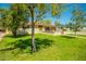 Charming home featuring a well-maintained lawn and inviting front porch, shaded by mature trees on a sunny day at 2246 E Glenrosa Ave, Phoenix, AZ 85016