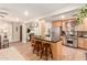 Open kitchen showcasing stainless steel appliances, breakfast bar seating, and seamless access to dining area at 2246 E Glenrosa Ave, Phoenix, AZ 85016