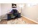 Functional home office with a desk, chair, drawers, and natural light for a productive workspace at 2246 E Glenrosa Ave, Phoenix, AZ 85016