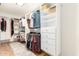 Spacious walk-in closet with custom shelving, drawers and hanging rods for optimal storage and organization at 2246 E Glenrosa Ave, Phoenix, AZ 85016