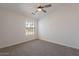 Bedroom with carpeted floors and a window overlooking the neighborhood at 2311 N Loma Vis, Mesa, AZ 85213