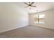 Bright bedroom with neutral walls, carpet, ceiling fan and window view of the backyard pool at 2311 N Loma Vis, Mesa, AZ 85213