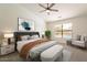 Bedroom with a queen-sized bed, ensuite bathroom, ceiling fan, and neutral walls at 2311 N Loma Vis, Mesa, AZ 85213