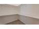 Spacious walk-in closet with ample shelving and carpeted flooring at 2311 N Loma Vis, Mesa, AZ 85213