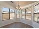 Bright dining area featuring a modern light fixture and large windows overlooking a backyard at 2311 N Loma Vis, Mesa, AZ 85213