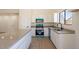Bright kitchen boasts white cabinets, stone countertops, center island, and modern, colored appliances at 2311 N Loma Vis, Mesa, AZ 85213