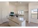 Updated kitchen with white cabinets, center island, stone countertops and modern, colored appliances at 2311 N Loma Vis, Mesa, AZ 85213