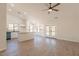 Open-concept layout showcases wood-look floors, kitchen island, and access to outdoor living spaces at 2311 N Loma Vis, Mesa, AZ 85213