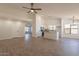 Open living space seamlessly transitions to the kitchen featuring wood-look floors and neutral paint at 2311 N Loma Vis, Mesa, AZ 85213