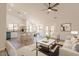 Open-concept layout with a kitchen island, barstool seating, and modern furnishings at 2311 N Loma Vis, Mesa, AZ 85213