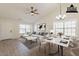 Staged living room featuring vaulted ceilings, modern decor, stylish ceiling fan, and bright windows at 2311 N Loma Vis, Mesa, AZ 85213