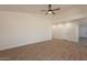 Bright living room features wood floors, ceiling fan, neutral walls, and archway to hallway at 2311 N Loma Vis, Mesa, AZ 85213