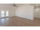 Large living space with wood-look flooring, vaulted ceilings, and access to the backyard at 2311 N Loma Vis, Mesa, AZ 85213