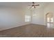 Spacious living room features wood-look flooring, a ceiling fan, natural light, and neutral walls at 2311 N Loma Vis, Mesa, AZ 85213