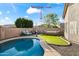 Inviting backyard pool and patio area, perfect for entertaining, featuring a hammock and ample seating under string lights at 2537 E Vista Bonita Dr, Phoenix, AZ 85024
