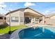 A private backyard with a sparkling pool, lush turf, covered patio, and ample space for outdoor activities at 2537 E Vista Bonita Dr, Phoenix, AZ 85024