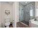 Bathroom featuring a glass shower, toilet, and wood-look flooring at 2537 E Vista Bonita Dr, Phoenix, AZ 85024