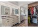 Bright bathroom featuring double vanity, walk-in closet, and wood-look flooring at 2537 E Vista Bonita Dr, Phoenix, AZ 85024
