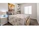 Bedroom with a patterned bedspread, side table, and decorative shelving at 2537 E Vista Bonita Dr, Phoenix, AZ 85024