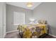 Cozy bedroom features wood flooring, floral comforter, and natural light from a window at 2537 E Vista Bonita Dr, Phoenix, AZ 85024