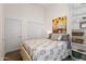 Bedroom with a patterned bedspread, built-in shelves, and wood-look flooring at 2537 E Vista Bonita Dr, Phoenix, AZ 85024