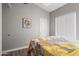 Bedroom featuring wood flooring, neutral walls, and a floral quilt with natural light from a window at 2537 E Vista Bonita Dr, Phoenix, AZ 85024