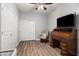 Inviting bedroom with wood flooring, roll-top desk, and a closet for storage solutions at 2537 E Vista Bonita Dr, Phoenix, AZ 85024