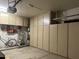 Spacious garage with built-in storage, ladder, and bicycle, offering ample organization at 2537 E Vista Bonita Dr, Phoenix, AZ 85024