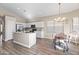 Bright eat-in kitchen featuring white cabinets, stainless steel appliances, and wood flooring at 2537 E Vista Bonita Dr, Phoenix, AZ 85024
