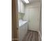 Laundry room with washer, dryer, shelving, and wood-look flooring providing functionality at 2537 E Vista Bonita Dr, Phoenix, AZ 85024