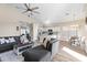 Open-concept living room with gray sofa, ceiling fan, and light, airy ambiance at 2537 E Vista Bonita Dr, Phoenix, AZ 85024