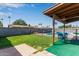 Backyard featuring lush green grass, a covered patio, and a fenced in pool area at 2541 E Inverness Ave, Mesa, AZ 85204