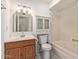 Traditional bathroom with a single sink vanity, medicine cabinet, and combination shower-tub at 2541 E Inverness Ave, Mesa, AZ 85204