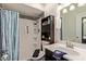 Modern bathroom with a walk-in shower, dark wood storage, and patterned accent wall at 2541 E Inverness Ave, Mesa, AZ 85204