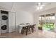 Bright dining area with sliding door to yard, laundry closet, ceiling fan, and tile flooring at 2541 E Inverness Ave, Mesa, AZ 85204